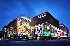 A modern building with large digital advertisements and a prominent sign reading 'THE HUB'. - Shanghai Kacunm Hotels (Shanghai)