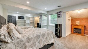 A bedroom with a bed, a fireplace, a mirror, and a closet. - 3BR Townhome Near Downtown Decatur (Decatur)