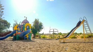 A playground with a slide and climbing structures. - Cortez RV Resort (Cortez)
