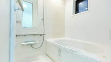 Combined shower/bathtub, hair dryer, slippers, towels