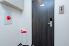 A door with a digital lock, a fire alarm, and a trash bin. - La Terrasse Higashikomagata by Tranova 2 (Sumida City)