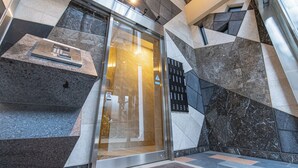 A modern elevator with a glass door, a control panel, and a keypad. - MODELLO Sangenjaya by Tranova 2 (Setagaya City)