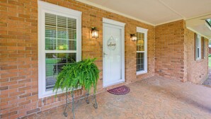 A brick house with a white door, two windows with shutters, and a potted plant. - Dublin Retreat Near Golf, Weddings & Tournaments (Dublin)