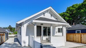 A single-story house with a front porch, a garage, and a fenced backyard. - Updated + Modern Craftsman Bungalow in Renton! (Renton)