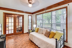 A bedroom with a bed, wooden floor, large windows, and a ceiling fan. - Walkable Location! Peaceful Toccoa Escape w/ Yard (Toccoa)