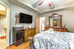 A bedroom with a bed, a television, a wooden dresser, a mirror, and a small refrigerator. - 4 Mi to Lake Houston! Single-Level Home w/ Yard (Humble)