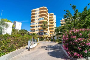 A multi-story residential building with balconies, surrounded by greenery and flowering plants. - Tahiti 2 7 by Casasol (Nerja)