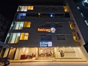 A building with a sign for Hotel Leggoo and Luna Eatery.