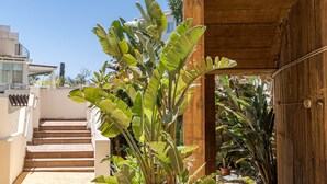 A staircase leading to a wooden structure, surrounded by lush banana plants. - Bv373a - Corner Penthouse With Rooftop Terrace (Mijas)