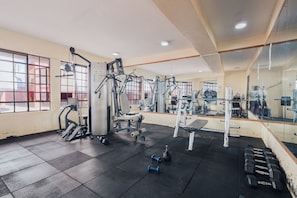 A gym with exercise equipment, a bench, and dumbbells. - 2 Bed Condo, Ensuite & Balcony, Near UN Nairobi in Ruaka (Nairobi)