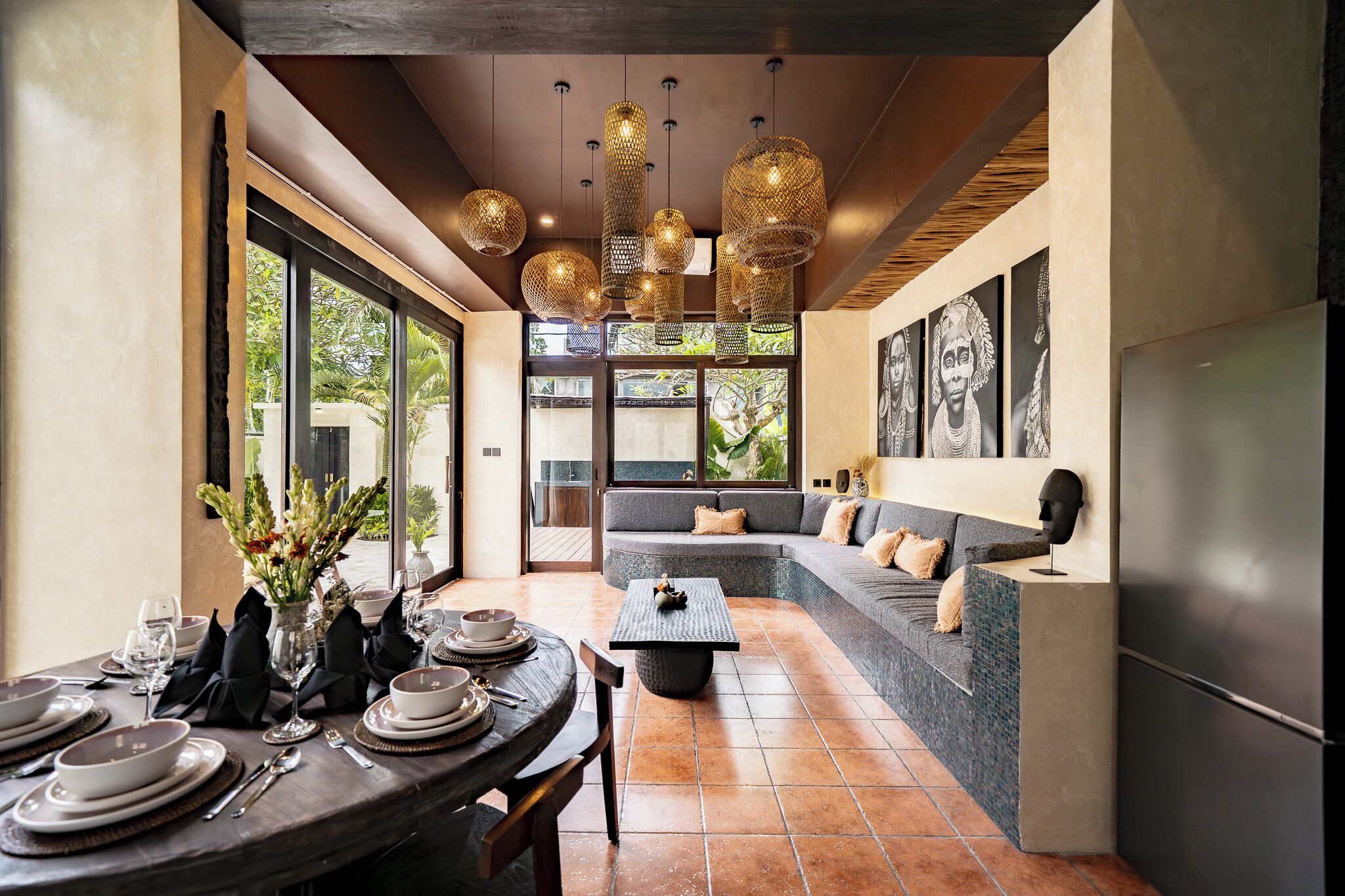A modern interior with a dining area, a seating area with a sofa, and a kitchen.