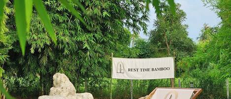 A bamboo-themed area with a lounge chair and a sign reading 'REST TIME BAMBOO'.