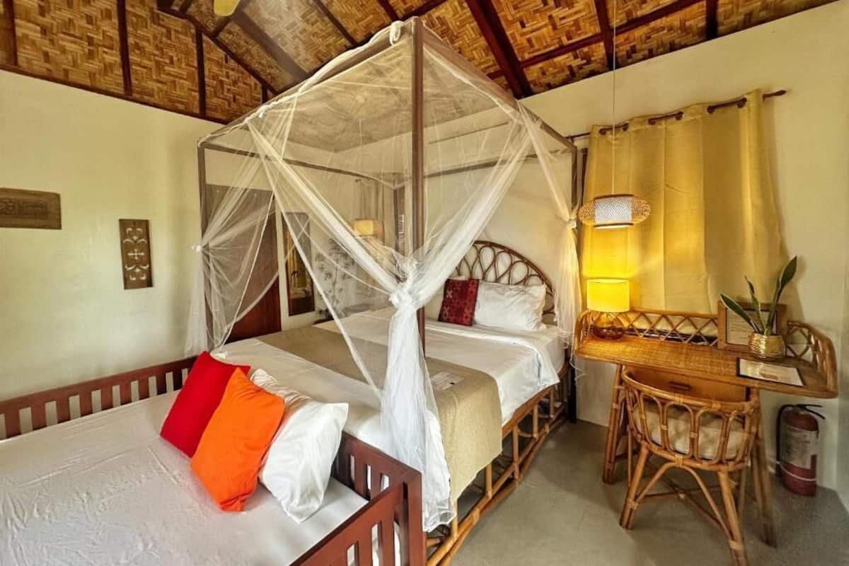 A room with a bed, a desk, and a chair.