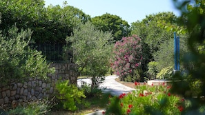 A stone wall, a pathway, and lush greenery. - Villa Kostrena in a green oasis by Villas Guide (Kostrena)