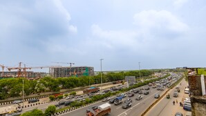 A busy multi-lane highway with vehicles, a construction site, and a pedestrian walkway. - The Lohias Premium - Delhi IGI Airport (New Delhi)