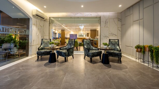 A modern lobby with marble walls, a reception desk, and seating areas. - The Lohias Premium - Delhi IGI Airport (New Delhi)