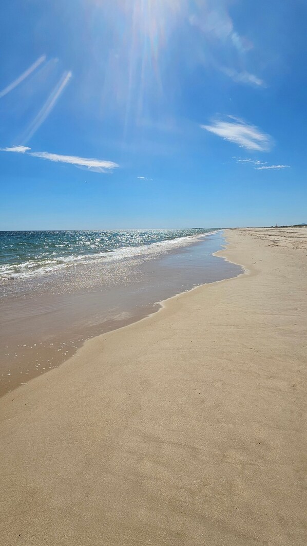 A beach with a clear sky, calm sea, and a sandy shore. - Palmview Penthouse Algarve - sea view, pool, golf & fantastic roof terrace (Conceicao de Tavira)