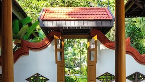 A covered entrance with a tiled roof, wooden pillars, and decorative wall panels.