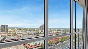 A cityscape view from a high-rise building with large windows. - Adelaide Central Skyline Panoramic Suite One (Adelaide)