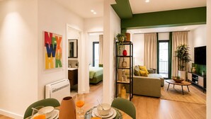A modern apartment with a dining area, a living room, and a bedroom. - LIV - Upscale Athenian Apartment 1C (Athens)