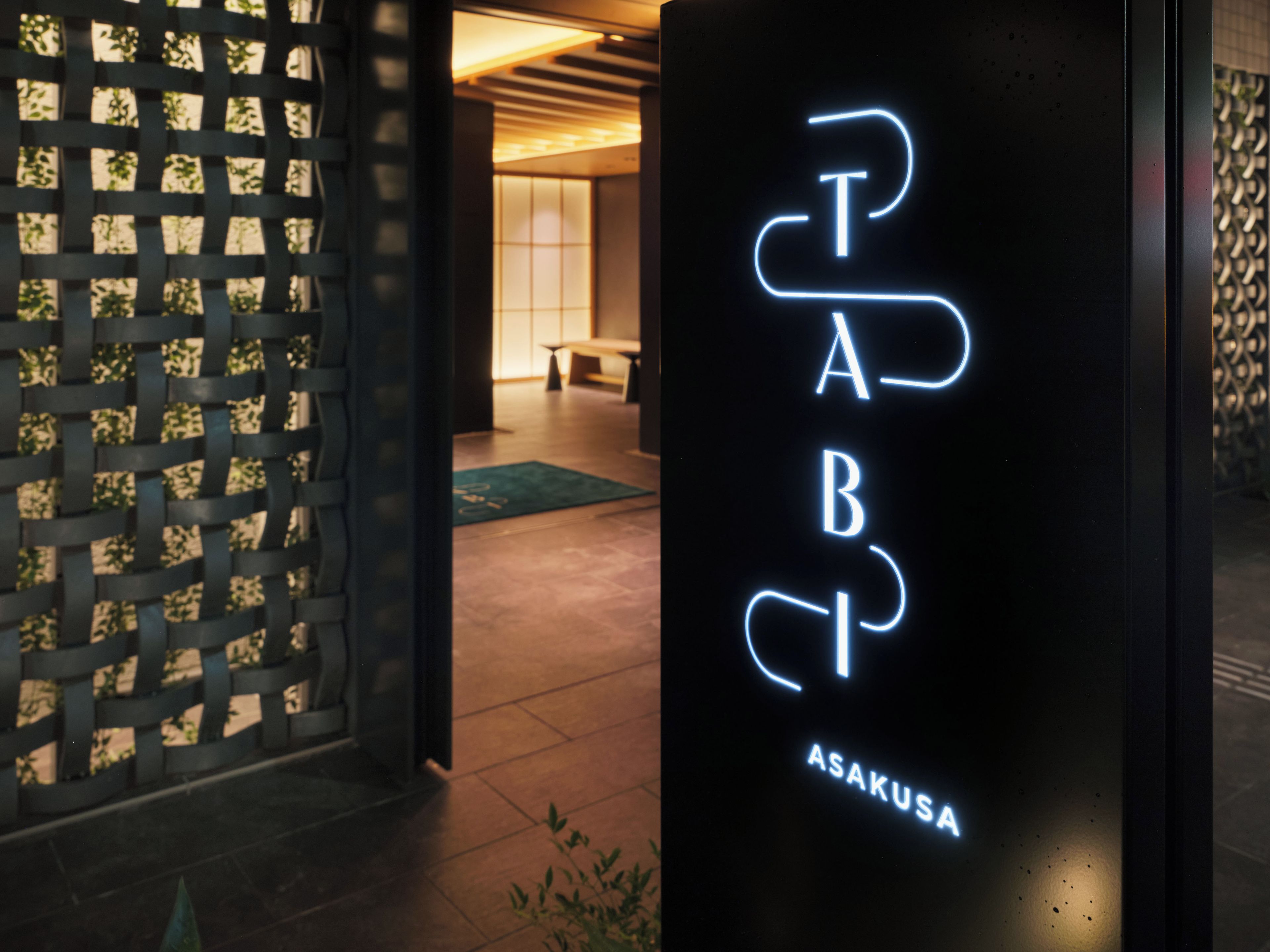 A neon sign with the letters 'PAB' and 'ASAKUSA' indicating a location or establishment.