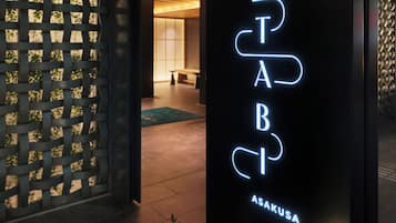 A neon sign with the letters 'PAB' and 'ASAKUSA' indicating a location or establishment.