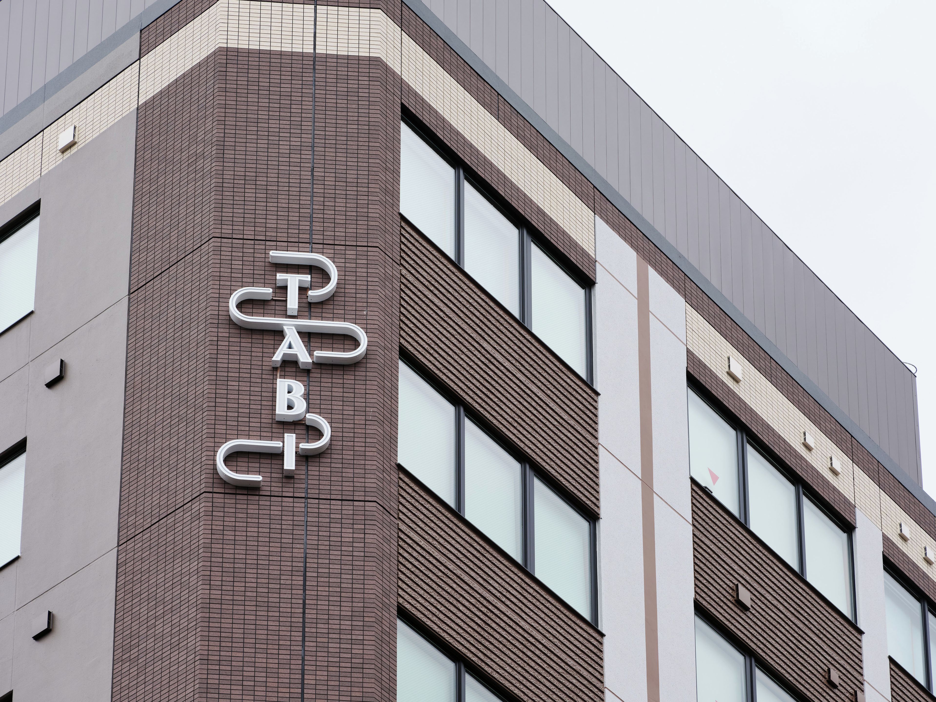 A building with a prominent sign reading 'TABBY' on the facade.
