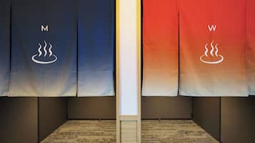 A room with two towels hanging on a wall, one labeled 'M' and the other 'W'.