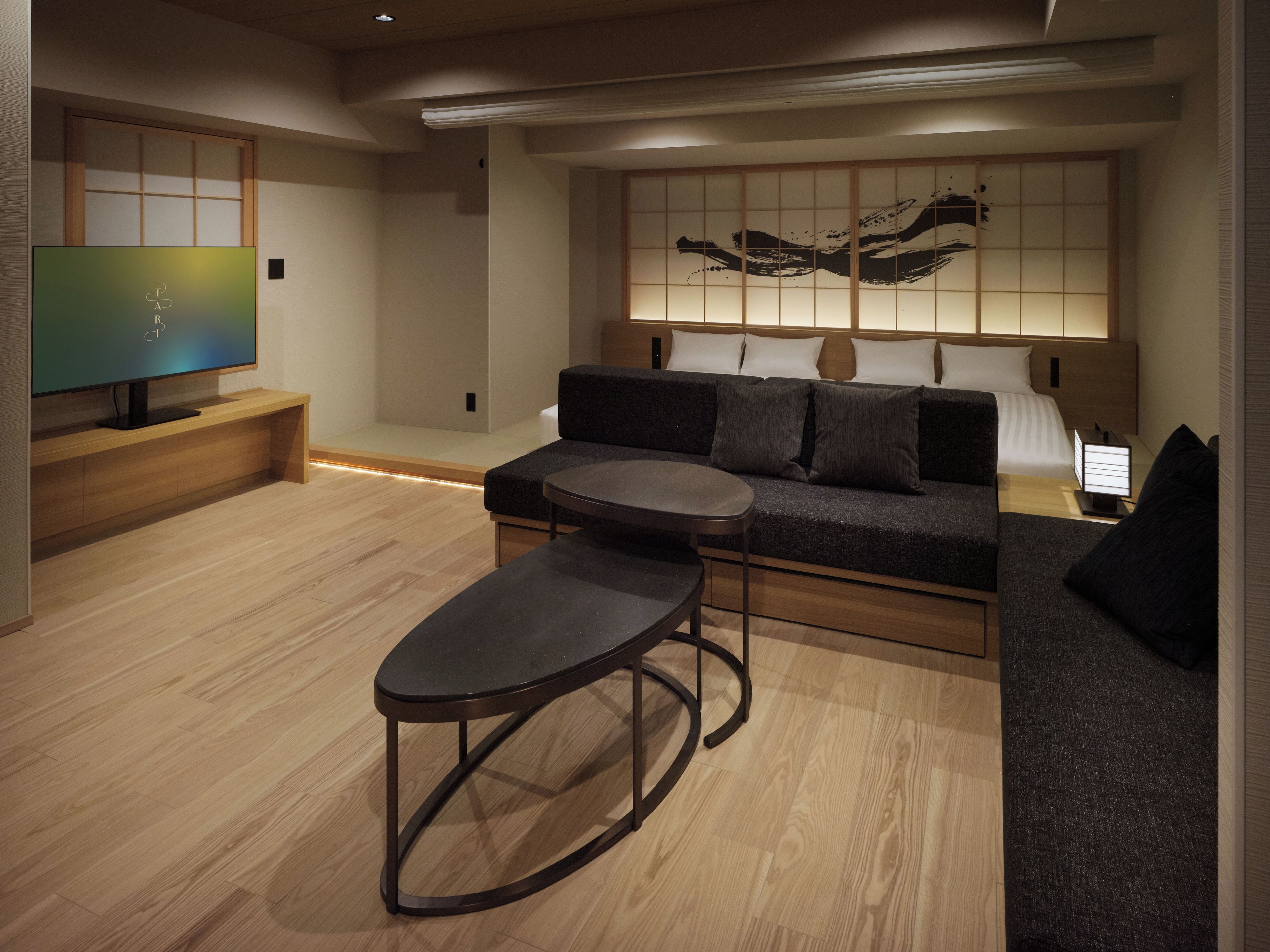 A modern living room with a sofa, a coffee table, and a television.