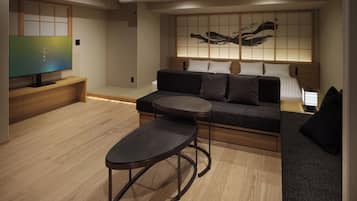 A modern living room with a sofa, a coffee table, and a television.