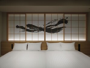 A hotel room with a large bed, two pillows, and a wall with a black abstract design. - TABI ASAKUSA (Tokyo)