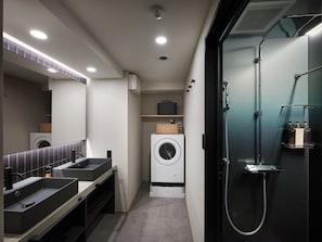 A modern bathroom with dual sinks, a large mirror, a washing machine, and a shower enclosure. - TABI ASAKUSA (Tokyo)