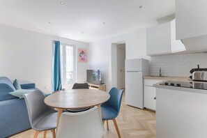 Eine moderne Wohnung mit Essbereich, Küche und Wohnzimmer.