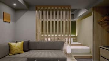 Una habitación de hotel moderna con un sofá gris, un separador de madera, una cama con ropa de cama blanca y un armario de madera.