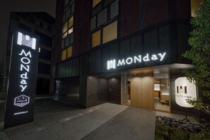 A building with a prominent 'MONDAY' sign, a modern design with dark and light brickwork, and a visible entrance. - Premium MONday ASAKUSA II (Tokyo)