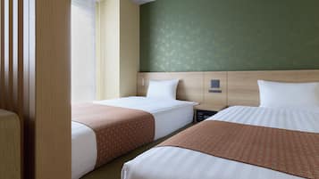 A hotel room with two beds, a nightstand, a control panel, and a window with blinds.