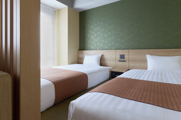 A hotel room with two beds, a nightstand, a control panel, and a window with blinds. - Premium MONday ASAKUSA II (Tokyo)