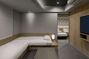 A hotel room with a bed, bedside table, lamp, and a TV. - Premium MONday ASAKUSA II (Tokyo)