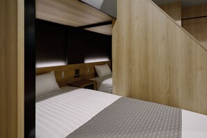 A hotel room with a bed, bedside tables, and a headboard. - Premium MONday ASAKUSA II (Tokyo)