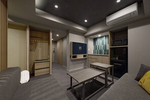 A modern, well-lit room with a built-in TV, a microwave, and a small kitchenette. - Premium MONday ASAKUSA II (Tokyo)