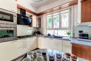 Eine moderne Küche mit Gasherd, Mikrowelle und Backofen.