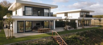 Luxury 16-person villa by the water. Two spacious homes with hot tubs, saunas, and a private jetty. Perfect for families and groups of friends!