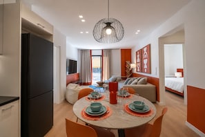 A modern hotel room with a dining area, a kitchen, a living area, and a bedroom. - LIV - Upscale Athenian Apartment 3B (Athens)