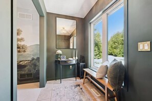 A bathroom with a large window, a mirror, a sink, and a clock. - Dacha - Private Retreat | Cold Plunge & Sauna (Lion's Head)