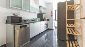 A modern kitchen with stainless steel appliances, a microwave, and a built-in oven.