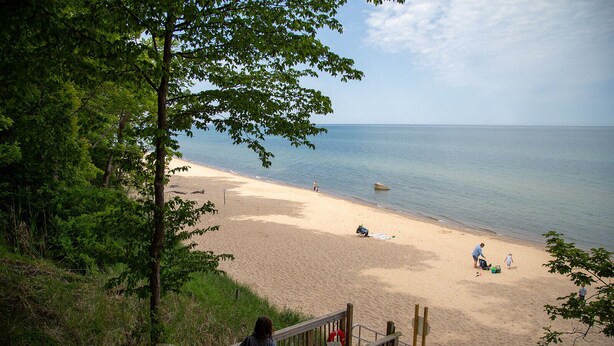 A beach with a wooden walkway leading down to the shore, a lifeguard stand, and a clear view of the sea. - Lakeside retreat minutes walk from Douglas Beach! (Douglas)
