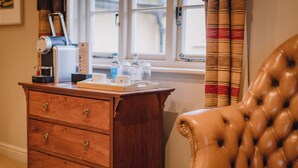 A wooden desk with a coffee machine, a tray with cups and a box, and a leather chair. - The Bildeston Crown (Bildeston)