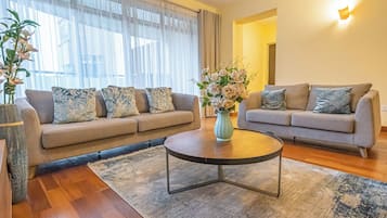 Deluxe Apartment | Living area | 42-inch flat-screen TV with digital channels