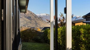 A view from a window with a mountain in the background.