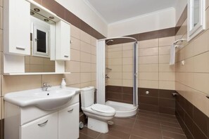 Ein Badezimmer mit Waschbecken, Toilette und Dusche.